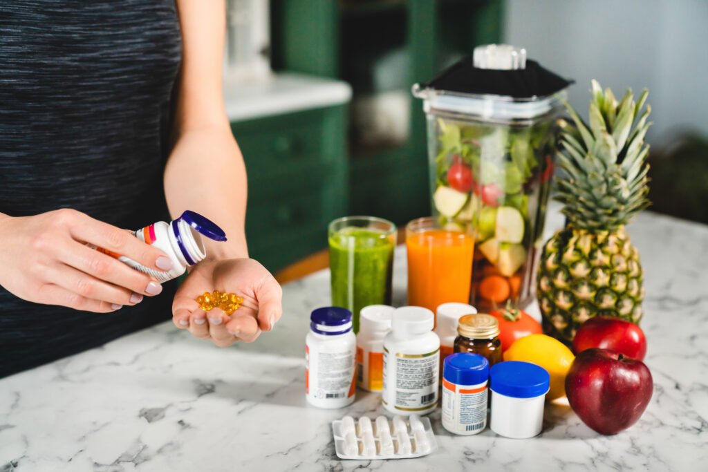 Woman taking NAD supplements in addition to healthy eating.